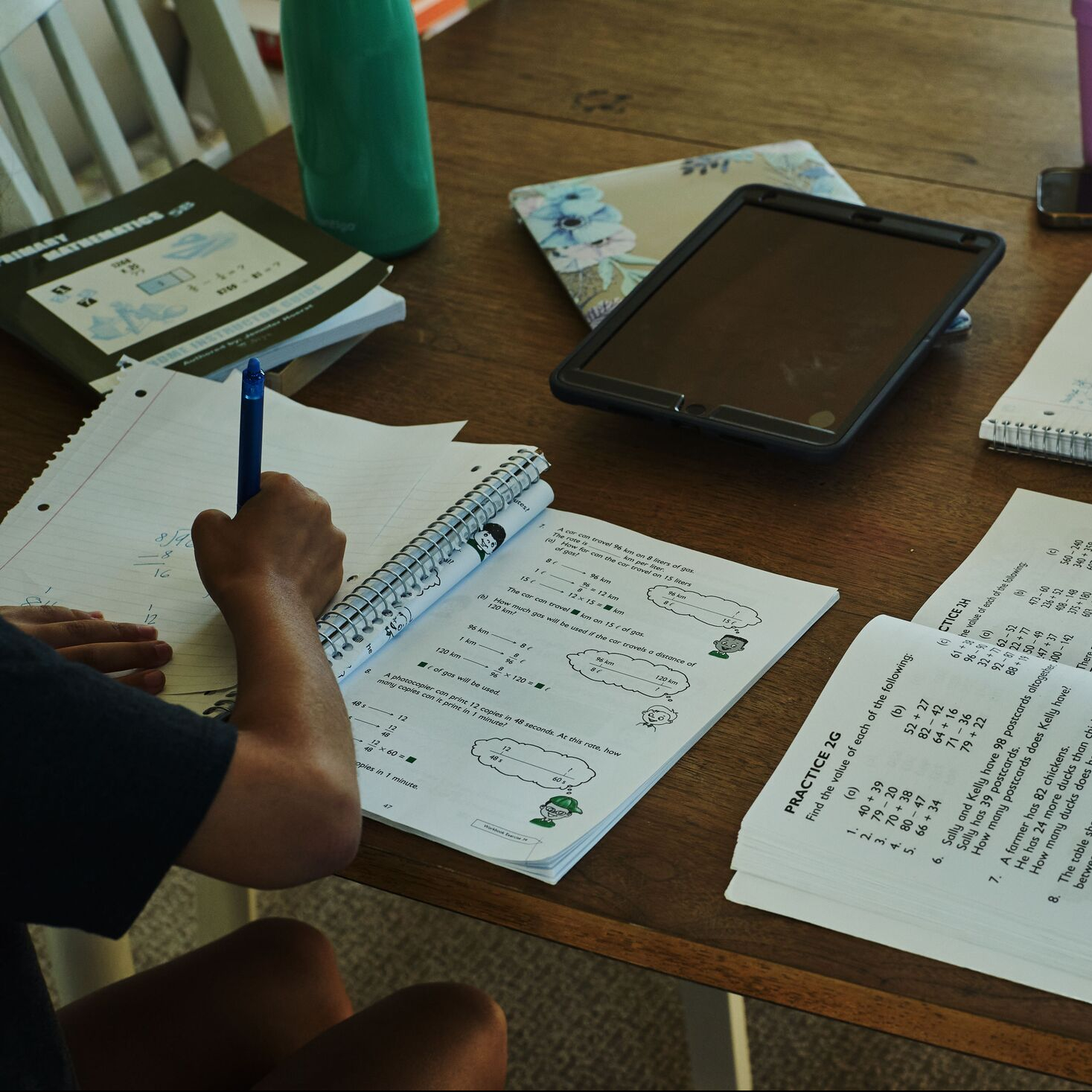 image of a student leaning over a notebook doing school work